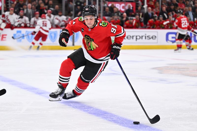 Apr 14, 2024; Chicago, Illinois, USA; Chicago Blackhawks forward Frank Nazar (91) skates the puck into the offensive zone in the third period against the Carolina Hurricanes at United Center. Mandatory Credit: Jamie Sabau-USA TODAY Sports