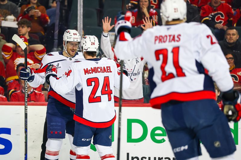 Jan 28, 2025; Calgary, Alberta, CAN; Washington Capitals left wing Pierre-Luc Dubois (80) celebrates his goal with teammates against the Calgary Flames during the first period at Scotiabank Saddledome. Mandatory Credit: Sergei Belski-Imagn Images