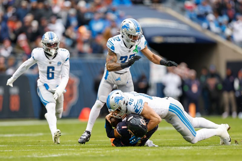 Chicago Bears quarterback Justin Fields (1) is tackled by Detroit Lions linebacker Jack Campbell (46) during the first half of an NFL football game, Sunday, Dec. 10, 2023, in Chicago. (AP Photo/Kamil Krzaczynski)