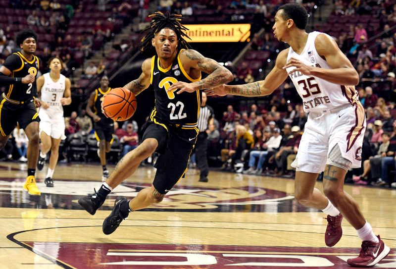 Feb 11, 2023; Tallahassee, Florida, USA; Pittsburgh Panthers guard Nike Sibande (22) drives to the net past Florida State Seminoles guard Matthew Cleveland (35) during the second half at Donald L. Tucker Center. Mandatory Credit: Melina Myers-USA TODAY Sports