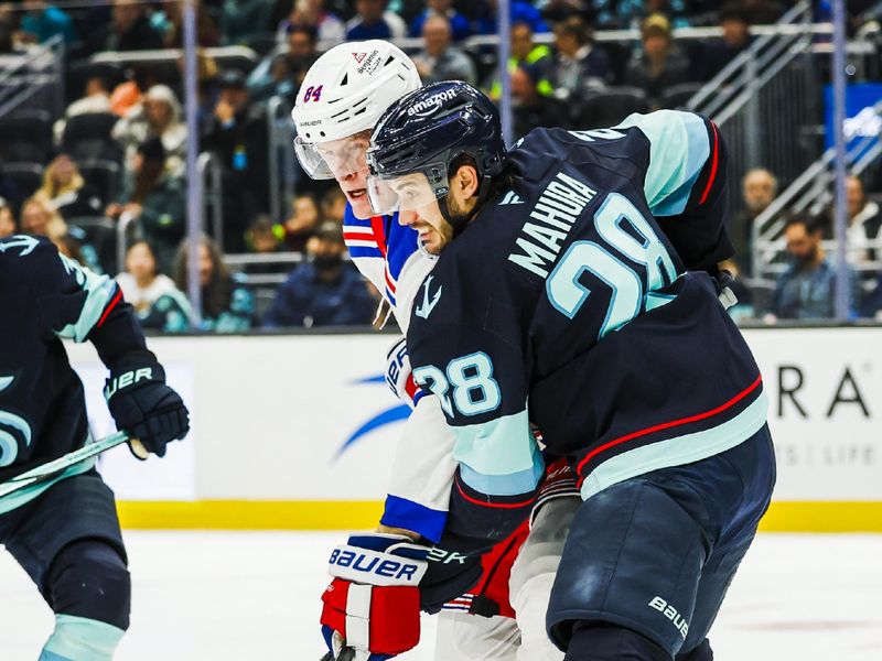 Nov 17, 2024; Seattle, Washington, USA; New York Rangers center Adam Edstrom (84) and Seattle Kraken defenseman Joshua Mahura (28) react to a shot attempt by the Rangers during the second period at Climate Pledge Arena. Mandatory Credit: Joe Nicholson-Imagn Images