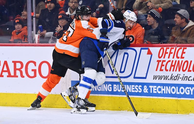 Jan 22, 2023; Philadelphia, Pennsylvania, USA; Philadelphia Flyers center Zack MacEwen (17) hits Winnipeg Jets defenseman Brenden Dillon (5) in the second period at Wells Fargo Center. Mandatory Credit: Kyle Ross-USA TODAY Sports