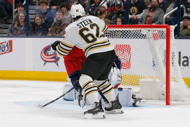 Jan 2, 2024; Columbus, Ohio, USA; Columbus Blue Jackets goalie Spencer Martin (30) makes a pad save as Boston Bruins center Oskar Steen (62) looks for a rebound during the second period at Nationwide Arena. Mandatory Credit: Russell LaBounty-USA TODAY Sports