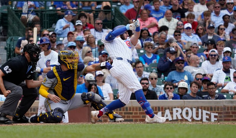 Jul 24, 2024; Chicago, Illinois, USA; Chicago Cubs third baseman Miles Mastrobuoni (20) hits a single against the Milwaukee Brewers during the seventh inning at Wrigley Field. Mandatory Credit: David Banks-USA TODAY Sports