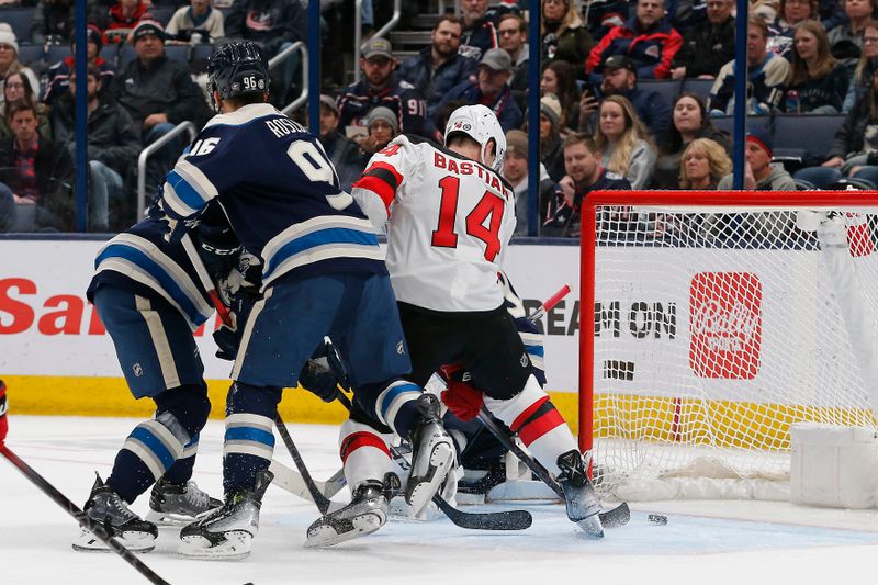 Jan 19, 2024; Columbus, Ohio, USA; New Jersey Devils right wing Nathan Bastian (14) tips the puck past Columbus Blue Jackets goalie Elvis Merzlikins (90) for a goal during the second period at Nationwide Arena. Mandatory Credit: Russell LaBounty-USA TODAY Sports