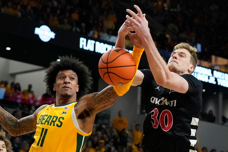 Jan 13, 2024; Waco, Texas, USA; Baylor Bears forward Jalen Bridges (11) and  Cincinnati Bearcats forward Viktor Lakhin (30) battle for the loose ball during the first half at Paul and Alejandra Foster Pavilion. Mandatory Credit: Raymond Carlin III-USA TODAY Sports