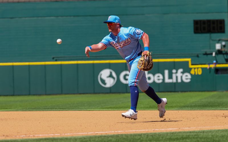 May 4, 2025; Arlington, Texas, USA;  Texas Rangers first baseman Blaine Crim (13) throws to first base during the seventh inning against the Seattle Mariners at Globe Life Field. Mandatory Credit: Kevin Jairaj-Imagn Images