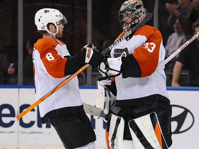 Apr 11, 2024; New York, New York, USA; Philadelphia Flyers goalie Samuel Ersson (33) celebrates a 4-1 win against the New York Rangers with defenseman Cam York (8) at Madison Square Garden. Mandatory Credit: Danny Wild-USA TODAY Sports