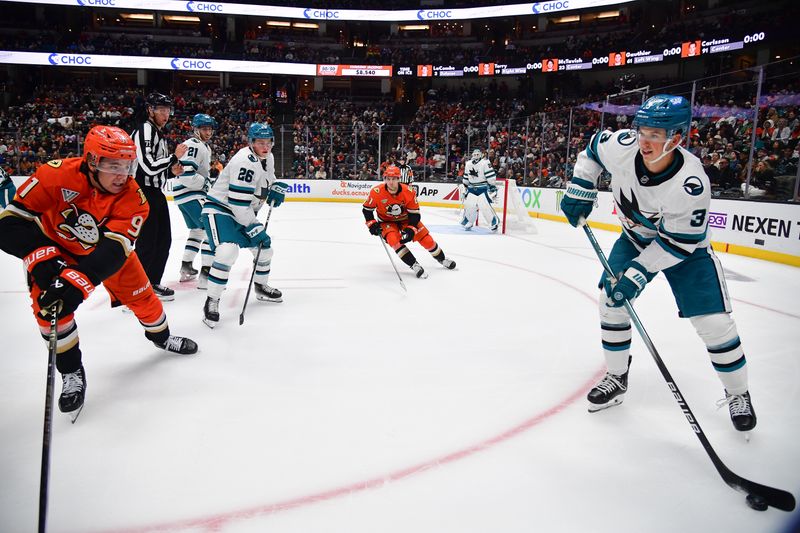 Oct 22, 2024; Anaheim, California, USA; San Jose Sharks defenseman Henry Thrun (3) moves the puck against Anaheim Ducks center Leo Carlsson (91)  during the second period at Honda Center. Mandatory Credit: Gary A. Vasquez-Imagn Images