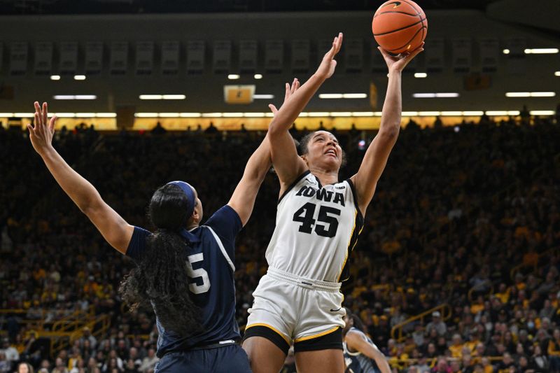 Feb 8, 2024; Iowa City, Iowa, USA; Iowa Hawkeyes forward Hannah Stuelke (45) goes to the basket as Penn State Nittany Lions guard Leilani Kapinus (5) defends during the second half at Carver-Hawkeye Arena. Mandatory Credit: Jeffrey Becker-USA TODAY Sports