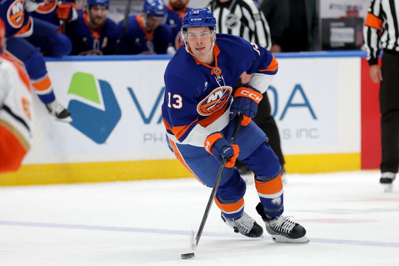 Dec 11, 2025; Elmont, New York, USA; New York Islanders center Mathew Barzal (13) skates with the puck against the Anaheim Ducks during the second period at UBS Arena. Mandatory Credit: Brad Penner-Imagn Images