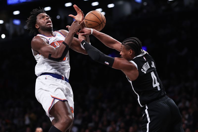 NEW YORK, NEW YORK - JANUARY 23: OG Anunoby #8 of the New York Knicks is fouled by Dennis Smith Jr. #4 of the Brooklyn Nets during the third quarter of the game at Barclays Center on January 23, 2024 in New York City.  NOTE TO USER: User expressly acknowledges and agrees that, by downloading and or using this photograph, User is consenting to the terms and conditions of the Getty Images License Agreement. (Photo by Dustin Satloff/Getty Images)