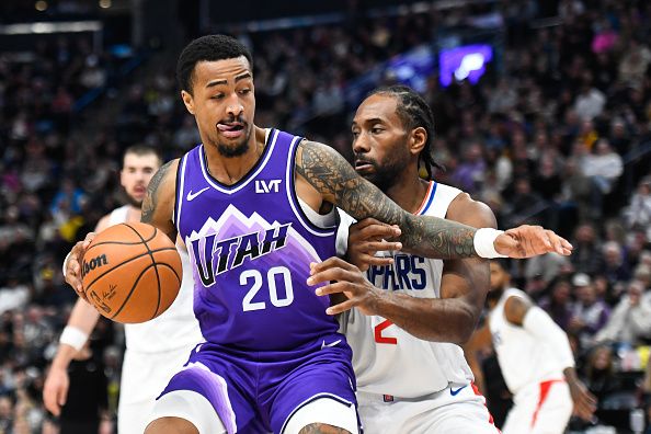 SALT LAKE CITY, UTAH - DECEMBER 08: John Collins #20 of the Utah Jazz drives into Kawhi Leonard #2 of the LA Clippers during the first half of a game at Delta Center on December 08, 2023 in Salt Lake City, Utah. NOTE TO USER: User expressly acknowledges and agrees that, by downloading and or using this photograph, User is consenting to the terms and conditions of the Getty Images License Agreement. (Photo by Alex Goodlett/Getty Images)