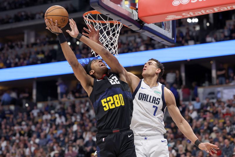 DENVER, COLORADO - DECEMBER 18: Zeke Nnaji #22 of the Denver Nuggets goes to the basket against Dwight Powell #7 of the Dallas Mavericks in the fourth quarter at Ball Arena on December 18, 2023 in Denver, Colorado. NOTE TO USER: User expressly acknowledges and agrees that, by downloading and or using this photograph, User is consenting to the terms and conditions of the Getty Images License Agreement.   (Photo by Matthew Stockman/Getty Images)