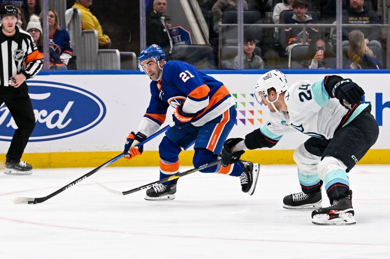 Feb 13, 2024; Elmont, New York, USA; New York Islanders center Kyle Palmieri (21) skates with the puck defended by New York Islanders defenseman Scott Mayfield (24) during the second period at UBS Arena. Mandatory Credit: Dennis Schneidler-USA TODAY Sports