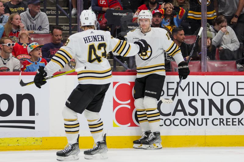 Nov 22, 2023; Sunrise, Florida, USA; Boston Bruins center Charlie Coyle (13) celebrates with center Danton Heinen (43) after scoring against the Florida Panthers during the first period at Amerant Bank Arena. Mandatory Credit: Sam Navarro-USA TODAY Sports