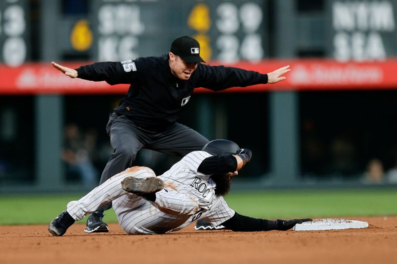 Aug 9, 2024; Denver, Colorado, USA; Colorado Rockies designated hitter Charlie Blackmon (19) is called safe by second base umpire Junior Valentine (25) in the fourth inning against the Atlanta Braves at Coors Field. Mandatory Credit: Isaiah J. Downing-USA TODAY Sports