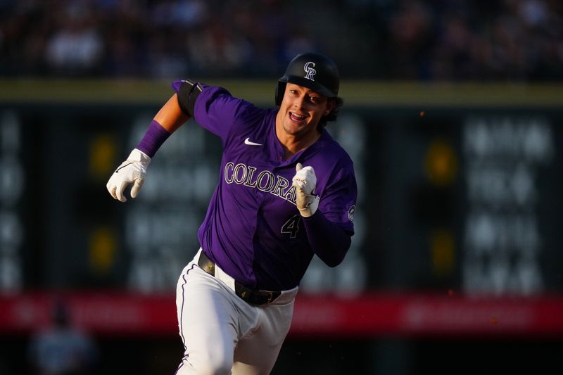 Jun 19, 2024; Denver, Colorado, USA; Colorado Rockies first base Michael Toglia (4) runs out a triple in the fourth inning against the Los Angeles Dodgers at Coors Field. Mandatory Credit: Ron Chenoy-USA TODAY Sports