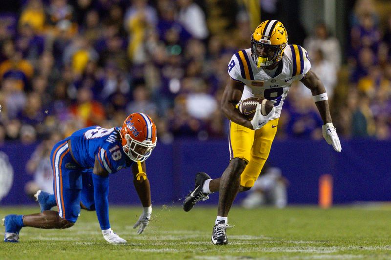 Nov 11, 2023; Baton Rouge, Louisiana, USA;  LSU Tigers wide receiver Malik Nabers (8) rushes away from the tackle of Florida Gators safety Bryce Thornton (18) during the second half at Tiger Stadium. Mandatory Credit: Stephen Lew-USA TODAY Sports