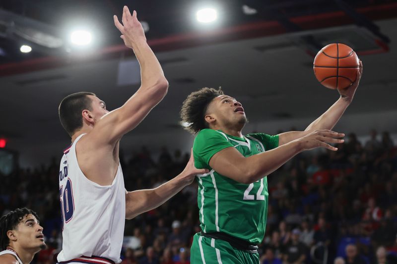 Jan 28, 2024; Boca Raton, Florida, USA; North Texas Mean Green guard CJ Noland (22) drives to the basket past Florida Atlantic Owls center Vladislav Goldin (50) during the first half at Eleanor R. Baldwin Arena. Mandatory Credit: Sam Navarro-USA TODAY Sports