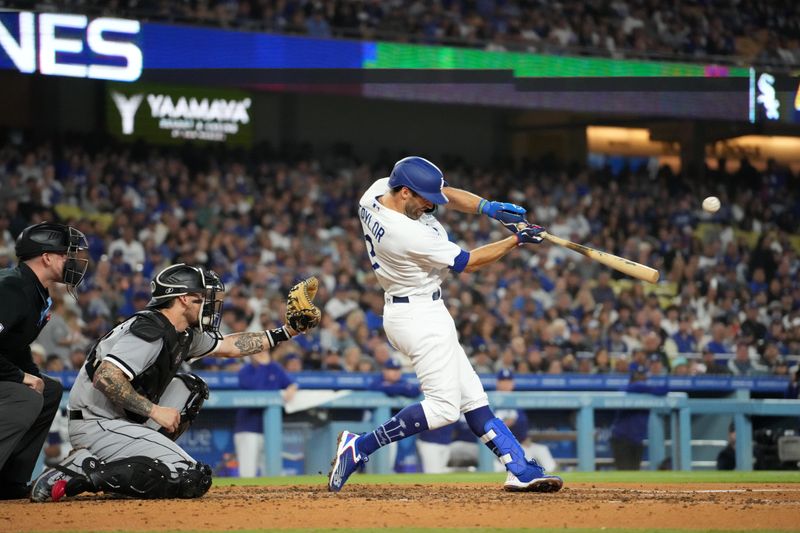 Jun 15, 2023; Los Angeles, California, USA; Los Angeles Dodgers third baseman Chris Taylor (3) follows through on a grand slam home run in the sixth inning as Chicago White Sox catcher Yasmani Grandal (24) watches at Dodger Stadium. Mandatory Credit: Kirby Lee-USA TODAY Sports