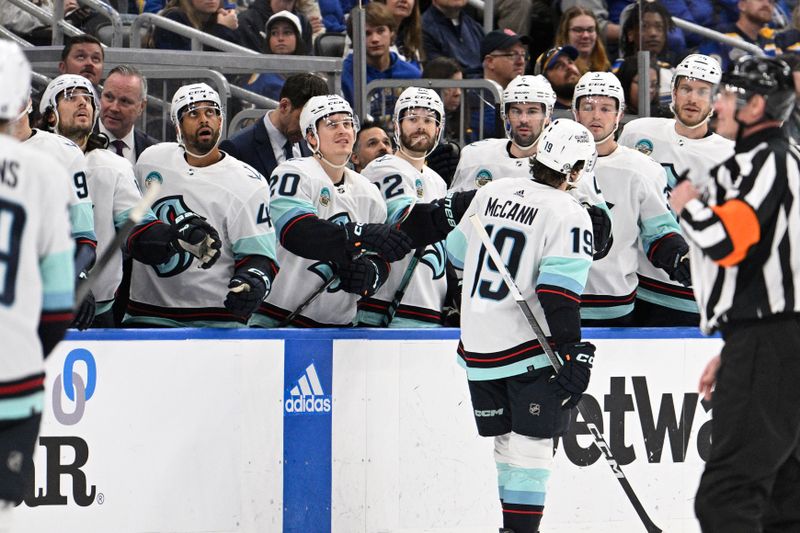 Apr 14, 2024; St. Louis, Missouri, USA; Seattle Kraken left wing Jared McCann (19) is congratulated by teammates after scoring a goal against the St. Louis Blues during the first period at Enterprise Center. Mandatory Credit: Jeff Le-USA TODAY Sports