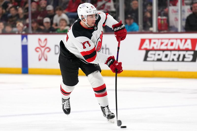 Mar 16, 2024; Tempe, Arizona, USA; New Jersey Devils defenseman Simon Nemec (17) shoots the puck against the Arizona Coyotes during the first period at Mullett Arena. Mandatory Credit: Joe Camporeale-USA TODAY Sports