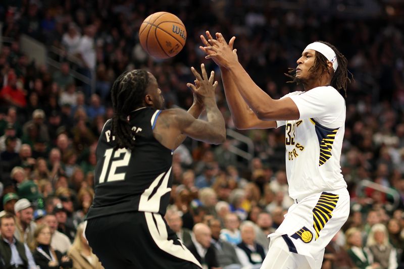 MILWAUKEE, WISCONSIN - NOVEMBER 22: Myles Turner #33 of the Indiana Pacers and Taurean Prince #12 of the Milwaukee Bucks reach for a loose ball during the first half of a game in the NBA Emirates Cup at Fiserv Forum on November 22, 2024 in Milwaukee, Wisconsin. NOTE TO USER: User expressly acknowledges and agrees that, by downloading and or using this photograph, User is consenting to the terms and conditions of the Getty Images License Agreement. (Photo by Stacy Revere/Getty Images)