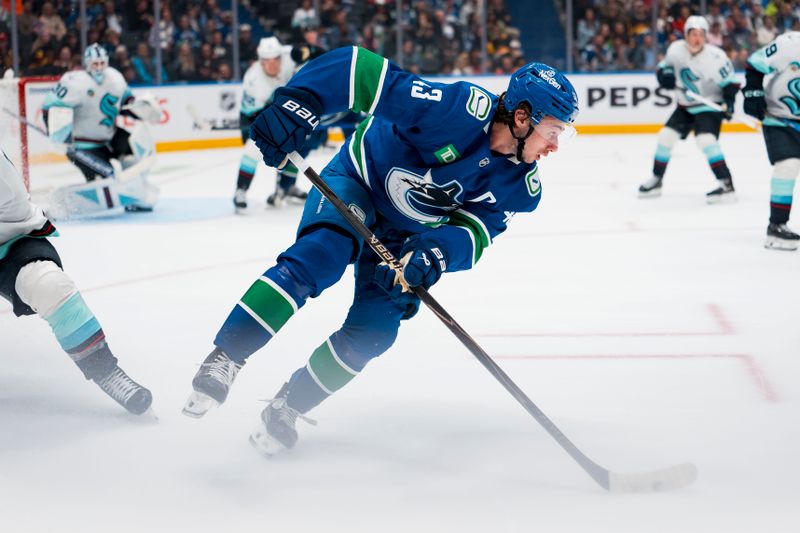 Sep 26, 2025; Vancouver, British Columbia, CAN; Vancouver Canucks defenseman Quinn Hughes (43) handles the puck against the Seattle Kraken in the third period at Rogers Arena. Mandatory Credit: Bob Frid-Imagn Images