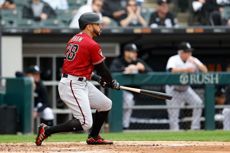 Sep 27, 2023; Chicago, Illinois, USA; Arizona Diamondbacks left fielder Tommy Pham (28) hits an RBI-single against the Chicago White Sox during the third inning at Guaranteed Rate Field. Mandatory Credit: Kamil Krzaczynski-USA TODAY Sports