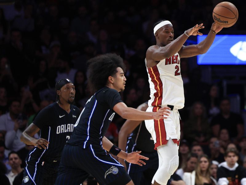 MIAMI, FLORIDA - OCTOBER 23: Jimmy Butler #22 of the Miami Heat passes over Anthony Black #0 of the Orlando Magic during the second half at Kaseya Center on October 23, 2024 in Miami, Florida. NOTE TO USER: User expressly acknowledges and agrees that, by downloading and or using this photograph, User is consenting to the terms and conditions of the Getty Images License Agreement. (Photo by Carmen Mandato/Getty Images)