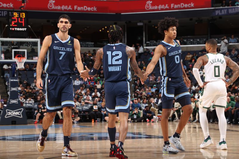 MEMPHIS, TN - OCTOBER 31: Santi Aldama #7, Ja Morant #12 and Jaylen Wells #0 of the Memphis Grizzlies high five during the game against the Milwaukee Bucks on October 31, 2024 at FedExForum in Memphis, Tennessee. NOTE TO USER: User expressly acknowledges and agrees that, by downloading and or using this photograph, User is consenting to the terms and conditions of the Getty Images License Agreement. Mandatory Copyright Notice: Copyright 2024 NBAE (Photo by Joe Murphy/NBAE via Getty Images)