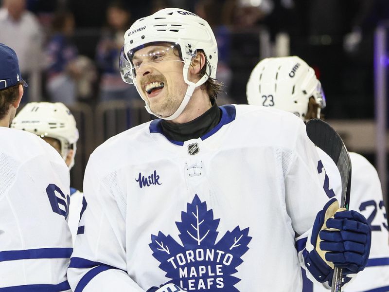 Feb 28, 2025; New York, New York, USA;  Toronto Maple Leafs defenseman Simon Benoit (2) celebrates after defeating the New York Rangers at Madison Square Garden. Mandatory Credit: Wendell Cruz-Imagn Images