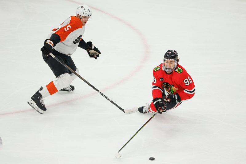 Feb 21, 2024; Chicago, Illinois, USA; Chicago Blackhawks center Connor Bedard (98) is fouled by Philadelphia Flyers defenseman Egor Zamula (5) during the first period at United Center. Mandatory Credit: Kamil Krzaczynski-USA TODAY Sports