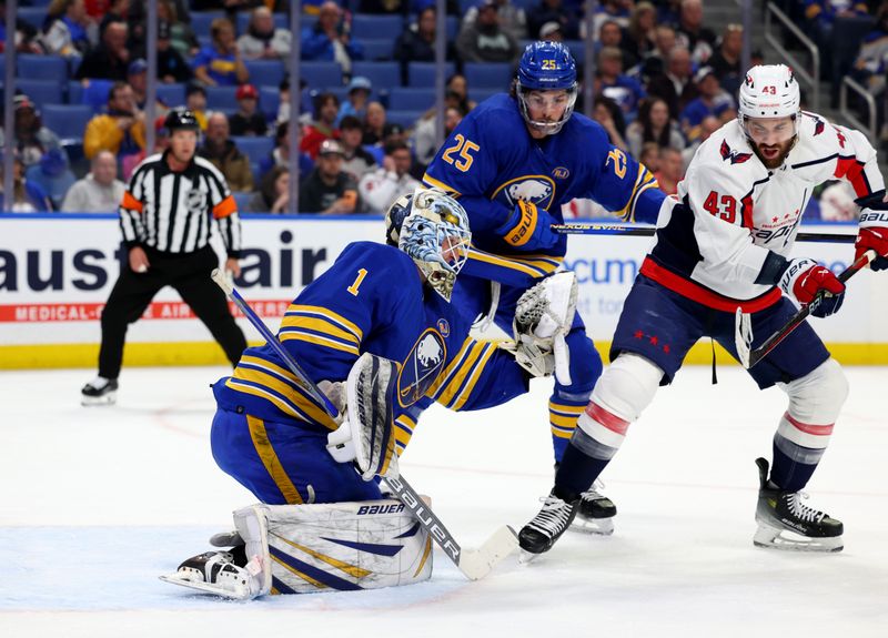 Apr 11, 2024; Buffalo, New York, USA;  Washington Capitals right wing Tom Wilson (43) tries to deflect a shot as Buffalo Sabres goaltender Ukko-Pekka Luukkonen (1) makes a save during the first period at KeyBank Center. Mandatory Credit: Timothy T. Ludwig-USA TODAY Sports