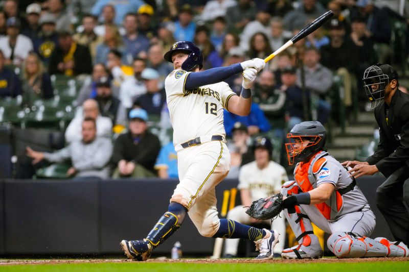 May 5, 2025; Milwaukee, Wisconsin, USA;  Milwaukee Brewers first baseman Rhys Hoskins (12) hits an RBI double during the eighth inning against the Houston Astros at American Family Field. Mandatory Credit: Jeff Hanisch-Imagn Images