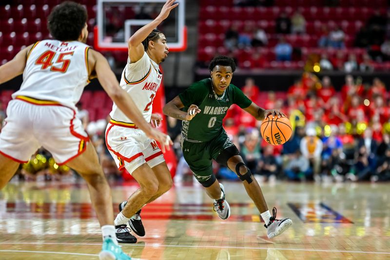 Dec 2, 2025; College Park, Maryland, USA; Wagner Seahawks guard Nick Jones (0) makes a move to the basket as Maryland Terrapins guard Myles Rice (2) defends during the first half  at Xfinity Center. Mandatory Credit: Tommy Gilligan-Imagn Images