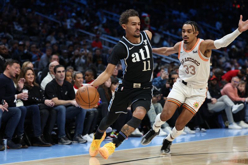 ATLANTA, GA - JANUARY 15: Trae Young #11 of the Atlanta Hawks handles the ball during the game against the San Antonio Spurs on January 15, 2024 at State Farm Arena in Atlanta, Georgia.  NOTE TO USER: User expressly acknowledges and agrees that, by downloading and/or using this Photograph, user is consenting to the terms and conditions of the Getty Images License Agreement. Mandatory Copyright Notice: Copyright 2024 NBAE (Photo by Mercedes Oliver/NBAE via Getty Images)