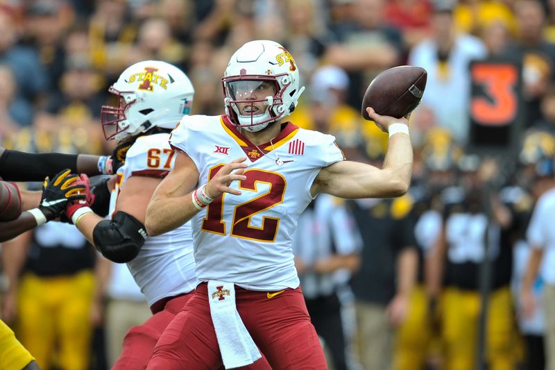 Sep 10, 2022; Iowa City, Iowa, USA; Iowa State Cyclones quarterback Hunter Dekkers (12) throws a pass against the Iowa Hawkeyes during the first quarter at Kinnick Stadium. Mandatory Credit: Jeffrey Becker-USA TODAY Sports