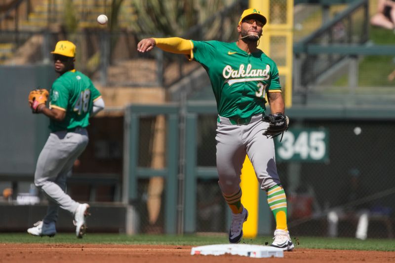 Mar 11, 2024; Salt River Pima-Maricopa, Arizona, USA; Oakland Athletics third baseman Abraham Toro (31) makes a throw to first base for an out against the Arizona Diamondbacks in the first inning at Salt River Fields at Talking Stick. Mandatory Credit: Rick Scuteri-USA TODAY Sports