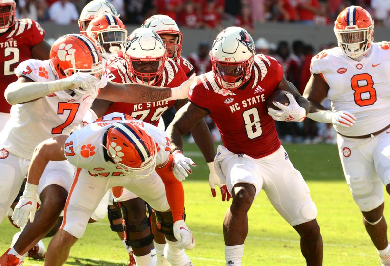 Sep 25, 2021; Raleigh, North Carolina, USA; North Carolina State Wolfpack running back Ricky Person Jr. (8) runst the ball during the first half against th Clemson Tigers at Carter-Finley Stadium. Mandatory Credit: Rob Kinnan-USA TODAY Sports