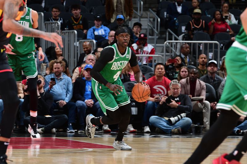 ATLANTA, GA - MARCH 28: Jrue Holiday #4 of the Boston Celtics dribbles the ball during the game against the Atlanta Hawks on March 28, 2024 at State Farm Arena in Atlanta, Georgia.  NOTE TO USER: User expressly acknowledges and agrees that, by downloading and/or using this Photograph, user is consenting to the terms and conditions of the Getty Images License Agreement. Mandatory Copyright Notice: Copyright 2024 NBAE (Photo by Scott Cunningham/NBAE via Getty Images)