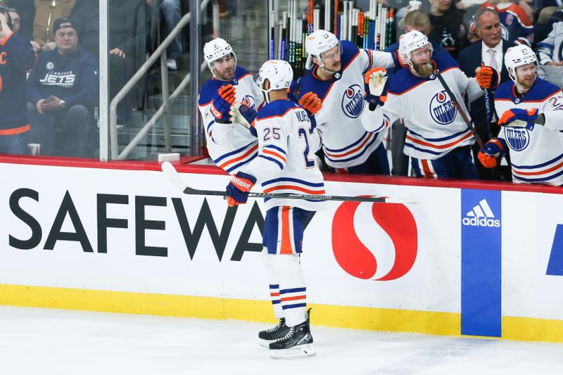 Nov 30, 2023; Winnipeg, Manitoba, CAN; Edmonton Oilers defenseman Darnell Nurse (25) is congratulated by his team mates on his goal against the Winnipeg Jets during the third period at Canada Life Centre. Mandatory Credit: Terrence Lee-USA TODAY Sports