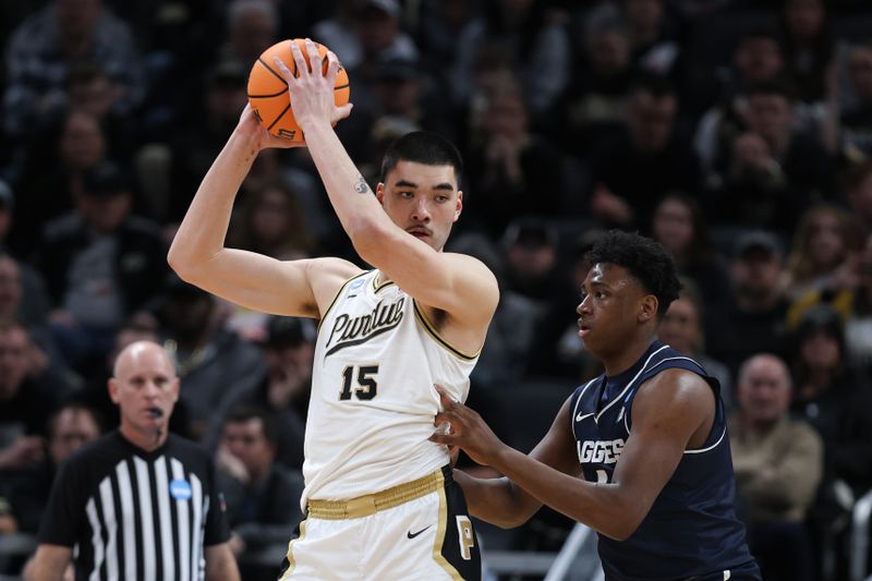 Mar 24, 2024; Indianapolis, IN, USA; Purdue Boilermakers center Zach Edey (15) holds the ball as Utah State Aggies forward Great Osobor (1) defends during the first half at Gainbridge FieldHouse. Mandatory Credit: Trevor Ruszkowski-USA TODAY Sports