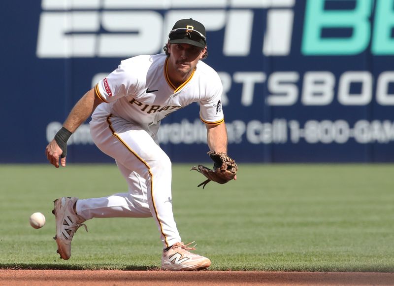 May 24, 2025; Pittsburgh, Pennsylvania, USA;  Pittsburgh Pirates second baseman Adam Frazier (26) fields a ground ball for an out against Milwaukee Brewers right fielder Sal Frelick (not pictured) during the fifth inning at PNC Park. Mandatory Credit: Charles LeClaire-Imagn Images