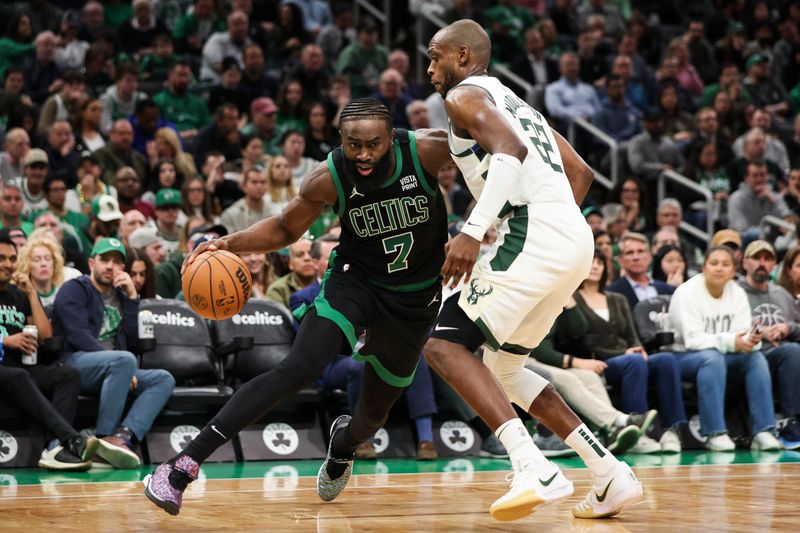 BOSTON, MA - MARCH 20:  Jaylen Brown #7 of the Boston Celtics drives to the basket against Khris Middleton #22 of the Milwaukee Bucks in the fourth quarter at TD Garden on March 20, 2024 in Boston, Massachusetts. NOTE TO USER: User expressly acknowledges and agrees that, by downloading and or using this photograph, User is consenting to the terms and conditions of the Getty Images License Agreement. (Photo by Adam Glanzman/Getty Images)