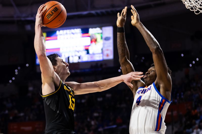 Feb 28, 2024; Gainesville, Florida, USA; Missouri Tigers forward Jesus Carralero Martin (13) attempts to make a layup over Florida Gators forward Tyrese Samuel (4) during the first half at Exactech Arena at the Stephen C. O'Connell Center. Mandatory Credit: Matt Pendleton-USA TODAY Sports