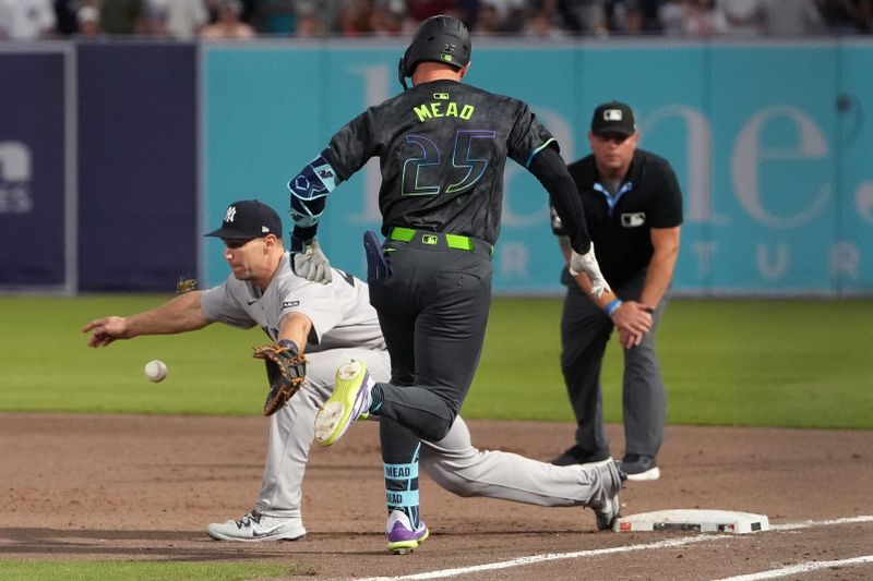 Apr 18, 2025; Tampa, Florida, USA; Tampa Bay Rays second baseman Curtis Mead (25) is out at first as New York Yankees first baseman Paul Goldschmidt (48) makes a tag during the fourth inning at George M. Steinbrenner Field. Mandatory Credit: Dave Nelson-Imagn Images