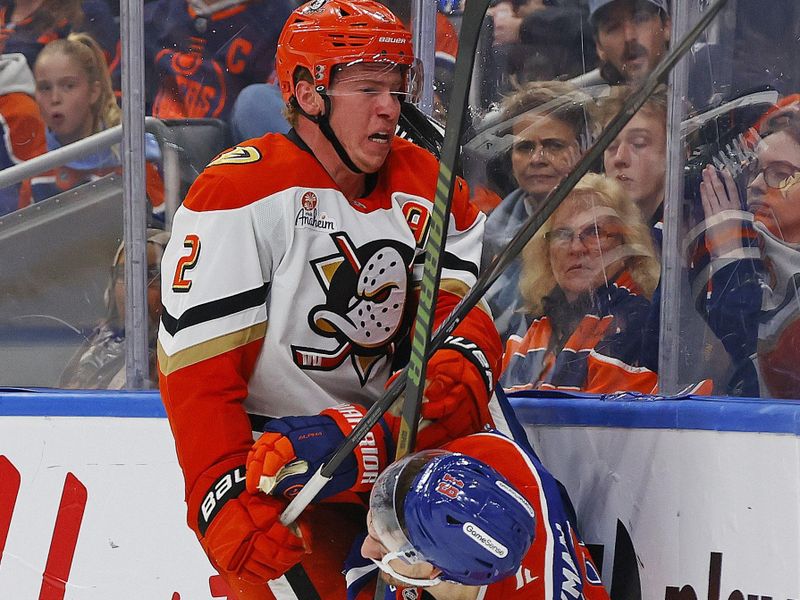Jan 26, 2026; Edmonton, Alberta, CAN;Anaheim Ducks defensemen Jackson LaCombe (2) checks Edmonton Oilers forward Zach Hyman (18) during the third period at Rogers Place. Mandatory Credit: Perry Nelson-Imagn Images