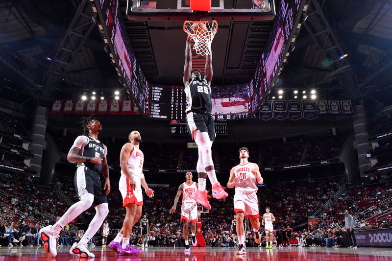 HOUSTON, TX - OCTOBER 17: Sidy Cissoko #25 of the San Antonio Spurs dunks the ball during the game against the Houston Rockets on October 17, 2024 at the Toyota Center in Houston, Texas. NOTE TO USER: User expressly acknowledges and agrees that, by downloading and or using this photograph, User is consenting to the terms and conditions of the Getty Images License Agreement. Mandatory Copyright Notice: Copyright 2024 NBAE (Photo by Logan Riely/NBAE via Getty Images)